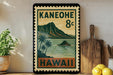 A vintage-style stamp depicting a tropical island landscape with palm trees and mountains, along with the text "KANEOHE 8c HAWAII" printed on it. The stamp is displayed on a shelf next to a wooden cutting board and a potted plant.