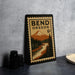 A metal sign with a vintage design depicting a mountain landscape and a river, along with the text "BEND OREGON 6c".