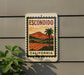 a sign that reads "ESCONDIDO CALIFORNIA" with a palm tree and a landscape scene, mounted on a wall.