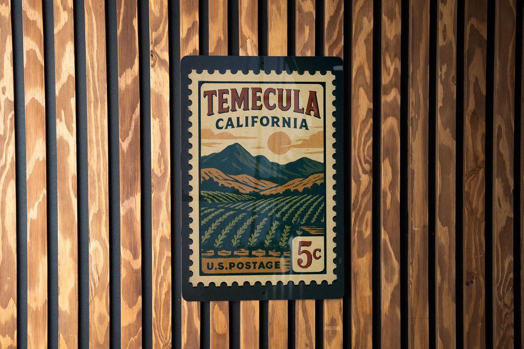 A vintage postage stamp from Temecula, California, featuring a mountainous landscape and a sun in the sky.
