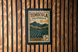 A vintage postage stamp from Temecula, California, featuring a mountainous landscape and a sun in the sky.
