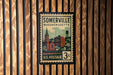 A vintage U.S. postage stamp from Somerville, Massachusetts, featuring a cityscape illustration.