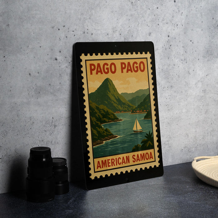 A framed poster of Pago Pago, an island in the South Pacific, featuring a sailboat and a mountainous landscape.