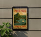 A vintage-style poster of Pago Pago, the island of Easter Island, with a sailboat and mountains in the background, is displayed on a wall.