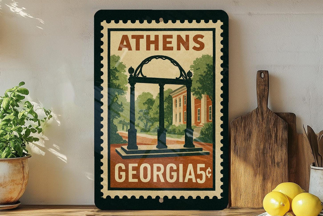 A framed poster of the University of Georgia's Arch, a historic building, is displayed on a shelf next to a wooden cutting board and some lemons.