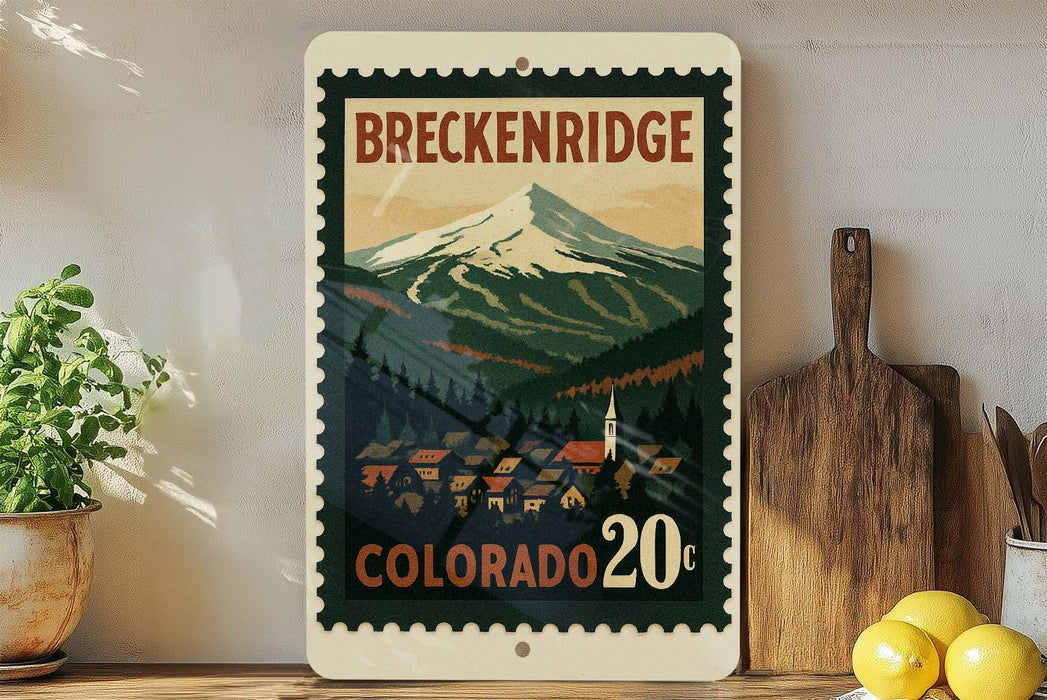 A framed vintage-style poster of Breckenridge, Colorado, featuring a mountain landscape with a small town in the foreground.
