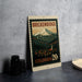 A metal sign with a mountain landscape and a small town in the background, featuring the text "BREKENRIDGE COLORADO 20¢".