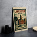 A vintage postage stamp from the United States of America, featuring an illustration of a town with a clock tower, placed on a table next to some black camera lenses.