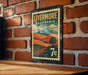A vintage-style metal stamp with the text "LIVERMORE CALIFORNIA" and a landscape illustration, mounted on a brick wall.