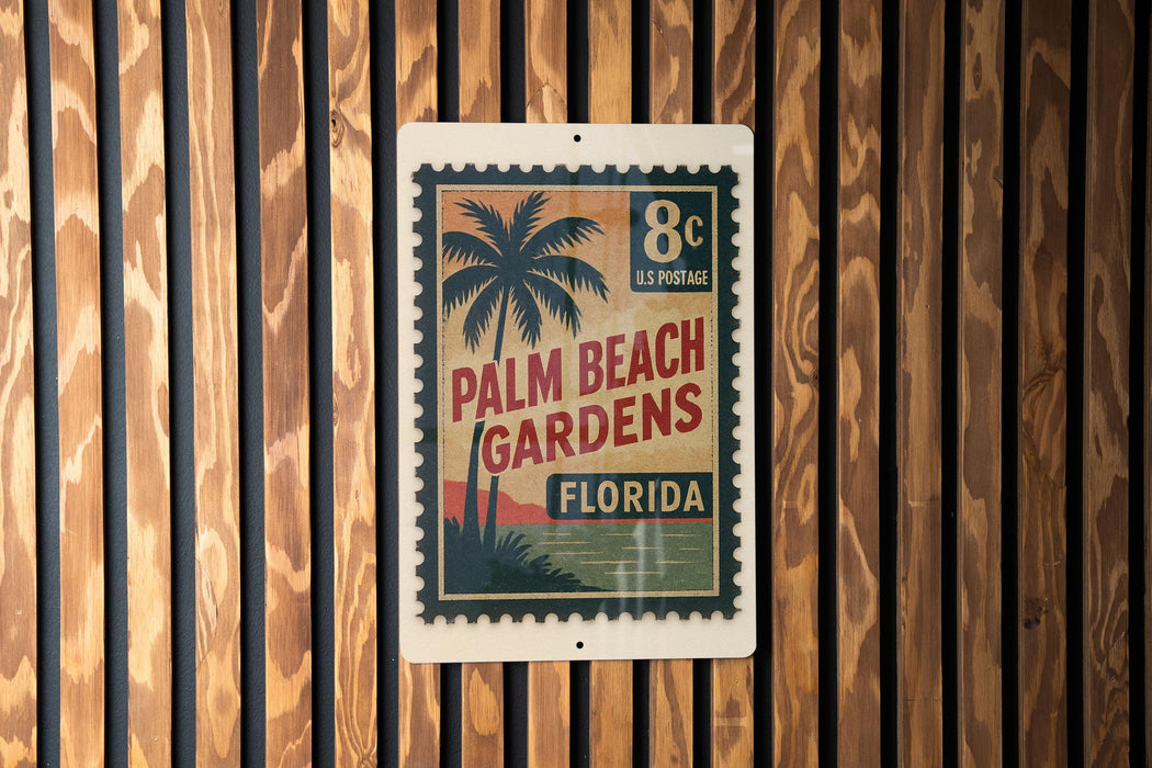A vintage-style postage stamp with a palm tree design, hanging on a wooden wall.