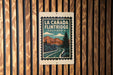 A sign for La Canada Flintridge, California, featuring a scenic mountain landscape with a winding road.