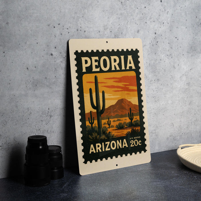 A metal sign with a desert landscape and cacti design, featuring the text "PEORIA ARIZONA 20¢" on it.