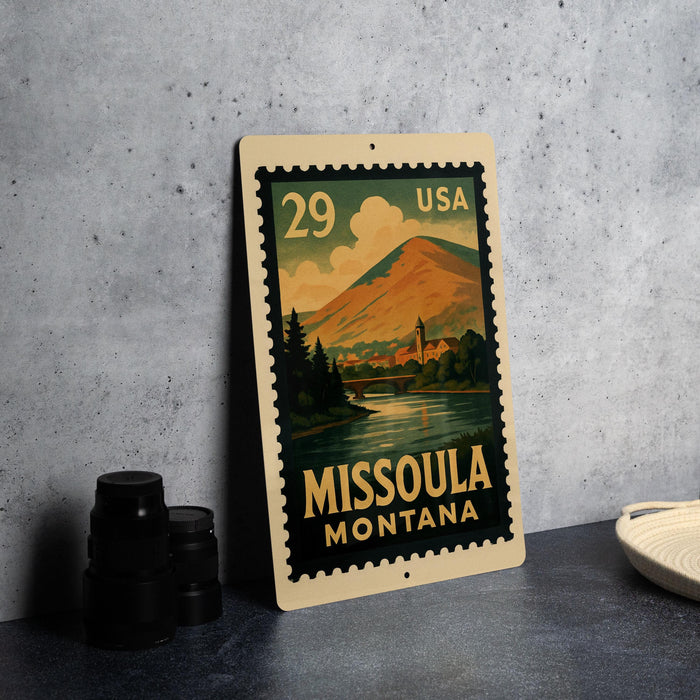 A metal sign with a mountain landscape and a river, featuring the text "29 USA" and "MISSOULA MONTANA".