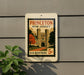 A vintage Princeton New Jersey postage stamp is displayed on a wall, with a plant to the left.