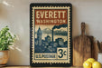 A vintage-style postage stamp from Everett, Washington, displayed on a shelf next to a wooden cutting board and some lemons.