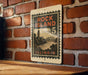 A vintage-style metal sign with the text "ROCK ISLAND 5 ILLINOIS" displayed on a brick wall.