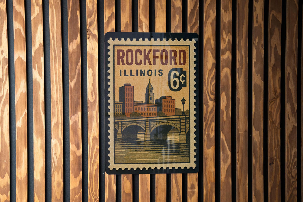 A vintage-style postage stamp from Rockford, Illinois, featuring a cityscape and a bridge.