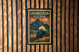 A vintage-style poster of Livingston, Montana, featuring a train and mountains in the background.