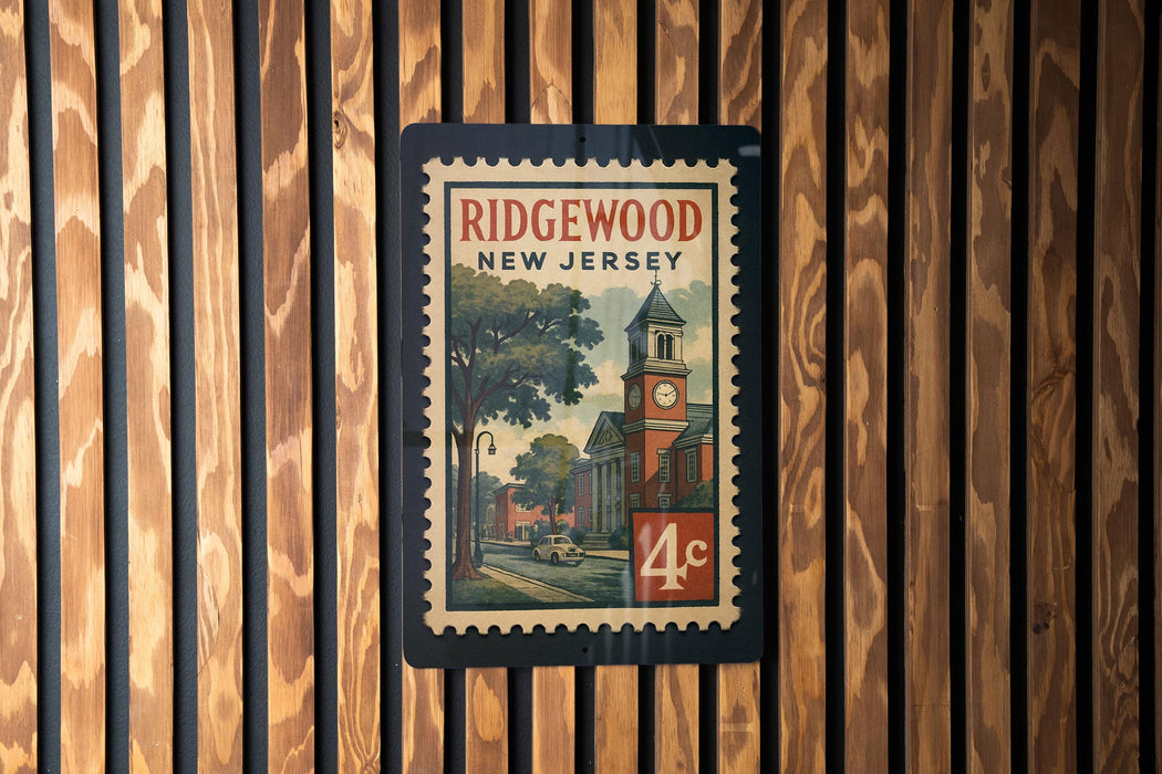 A vintage postage stamp from New Jersey featuring a building with a clock tower and a tree, mounted on a wooden wall.