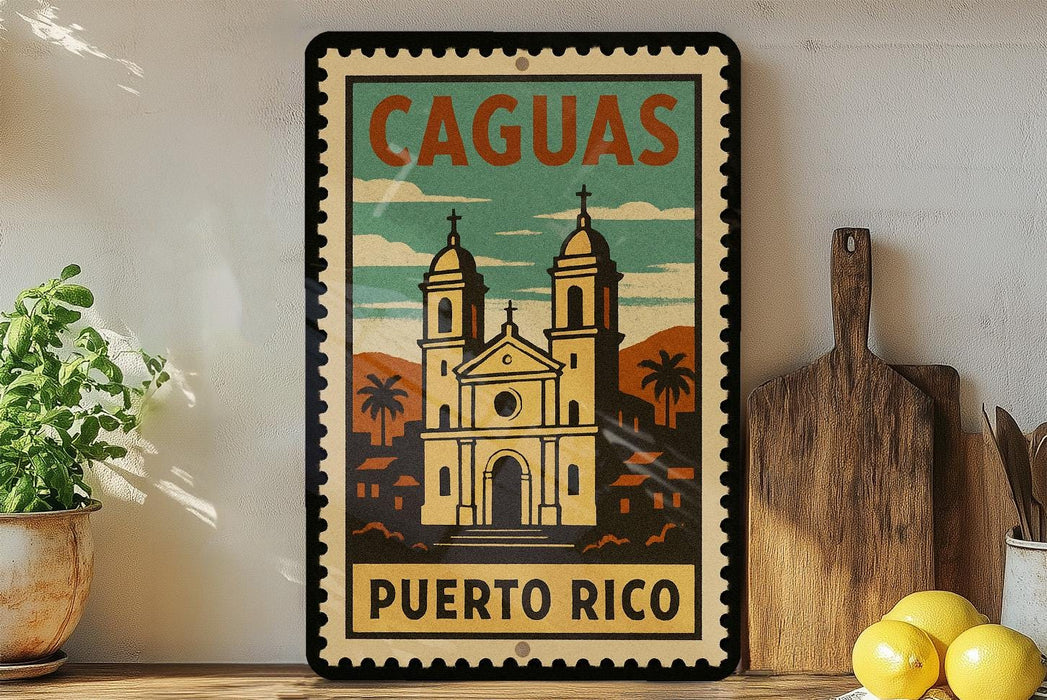 A vintage-style sign for Cagua, Puerto Rico, featuring an illustration of a church with two towers and palm trees, is displayed on a shelf next to a wooden cutting board and a potted plant.
