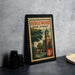 A framed poster of Ridgewood, New Jersey, featuring a street scene with a clock tower and a church, is displayed on a table.
