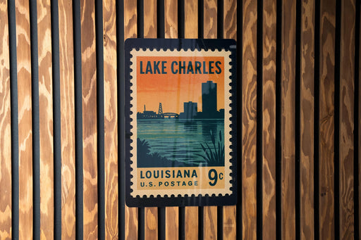 A vintage-style postage stamp from Louisiana, featuring a silhouette of a city skyline against a sunset backdrop.