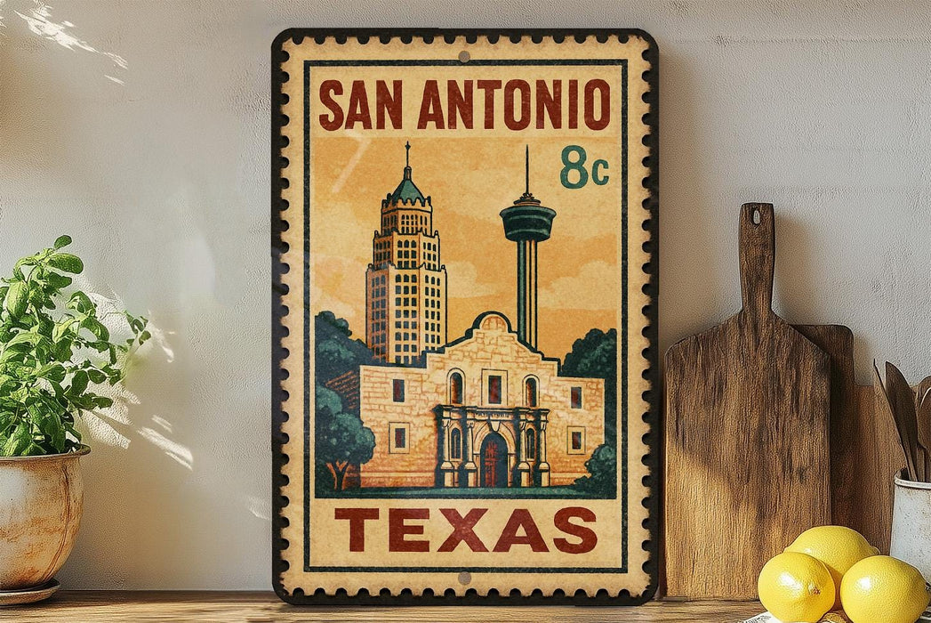A vintage-style metal sign with the text "SAN ANTONIO TEXAS" and an illustration of the historic Alamo in San Antonio, Texas.