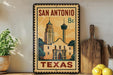 A vintage-style metal sign with the text "SAN ANTONIO TEXAS" and an illustration of the historic Alamo in San Antonio, Texas.