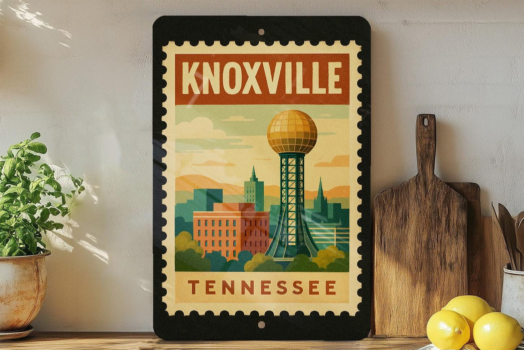 A framed poster of Knoxville, Tennessee, featuring a cityscape with a prominent tower, is displayed on a shelf next to a wooden cutting board and a potted plant.