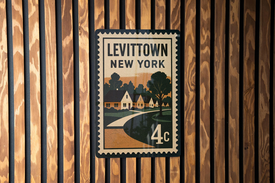 A vintage-style postage stamp depicting a street scene in Levitown, New York, with houses and trees.