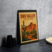 A framed poster of the Oro Valley in Arizona, featuring a desert landscape with cacti and mountains in the background.