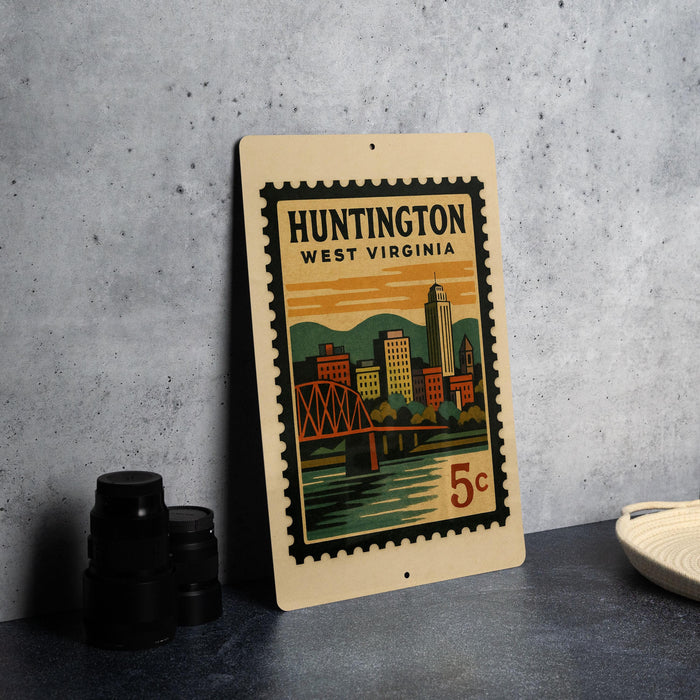A vintage postage stamp from Huntington, West Virginia, featuring an illustration of the city skyline and a bridge.