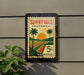 A vintage postage stamp from Sunnyvale, California, featuring a palm tree and a sunset landscape.