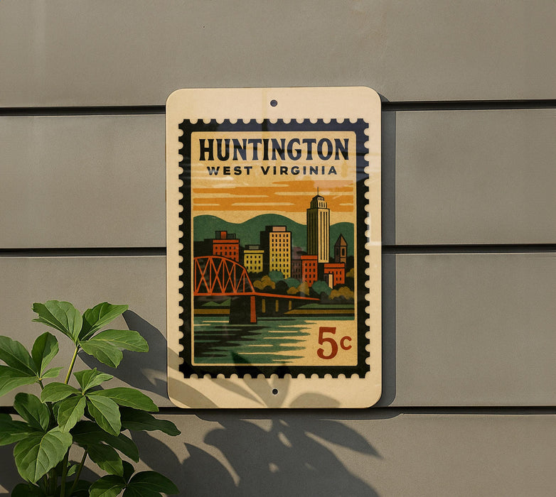 A vintage-style street sign for Huntington, West Virginia, featuring a colorful illustration of the city skyline and a bridge.