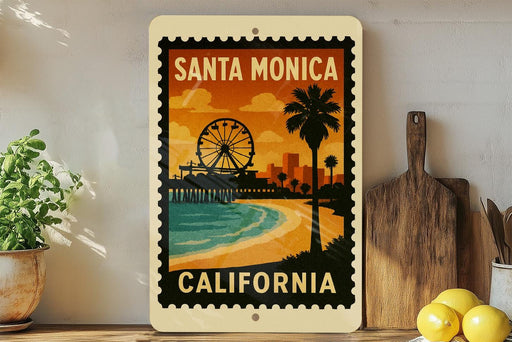 A framed poster of Santa Monica, California, featuring a ferris wheel and palm trees, is displayed on a wall next to a wooden cutting board and a potted plant.