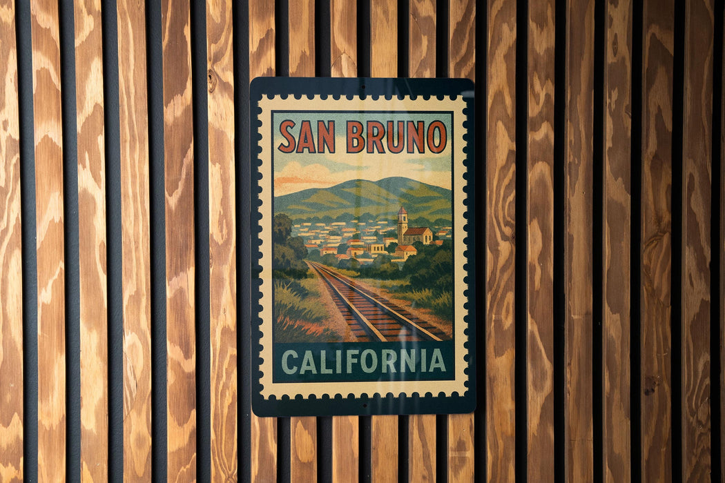 A vintage-style postage stamp from San Bruno, California, featuring a scenic landscape with train tracks and a small town in the background.