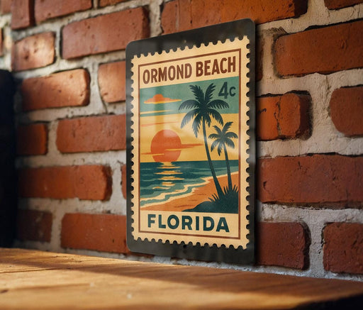 A vintage-style metal stamp depicting a tropical beach scene with palm trees and a sunset, mounted on a brick wall.