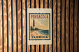 A vintage-style sign for Pensacola, Florida, featuring a lighthouse and the text "PENSACOLA FLORIDA" in a decorative font.
