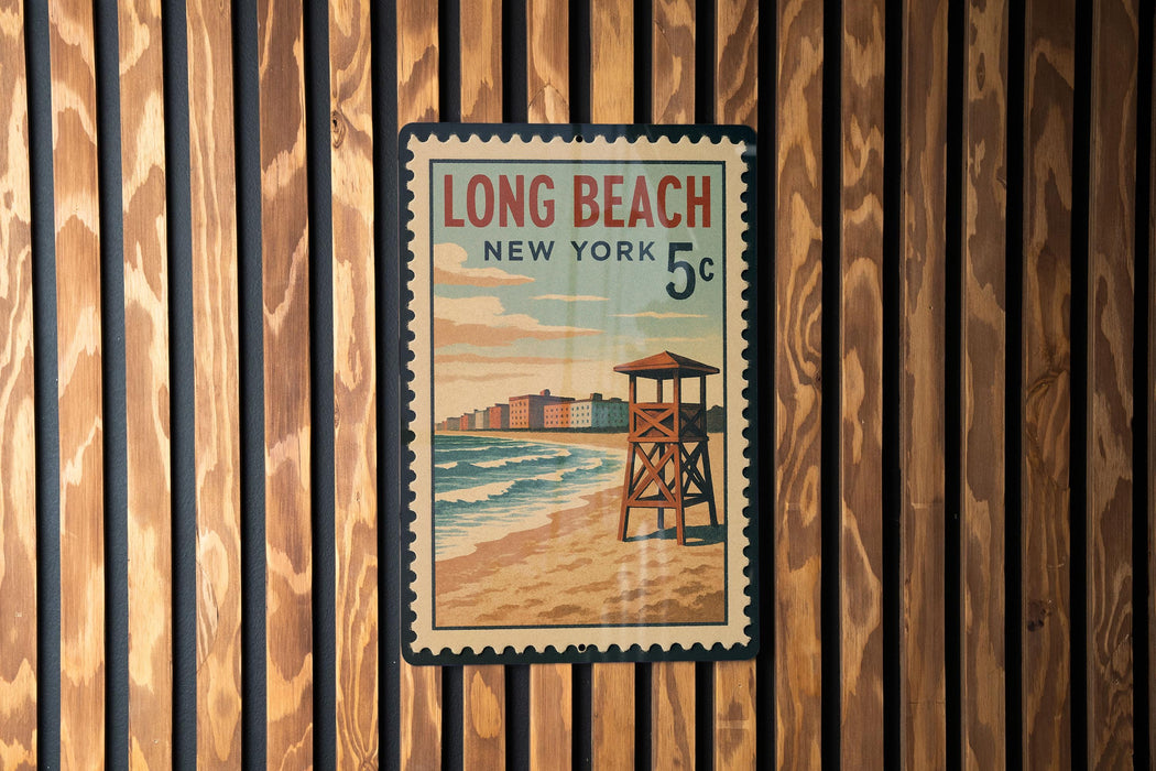 A vintage-style poster of Long Beach, New York, featuring a lifeguard tower and the ocean, is displayed on a wooden wall.