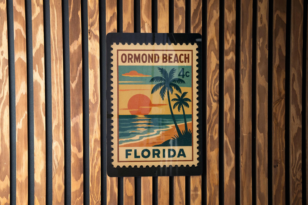 A vintage-style postage stamp from Florida, featuring a palm tree and sunset, is displayed on a wooden wall.