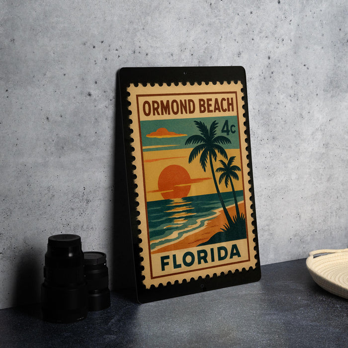 A framed poster of Ormond Beach, Florida, featuring a palm tree and sunset, is displayed on a countertop.