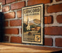 A vintage postage stamp from Concord, California, featuring a church and a mountain landscape.