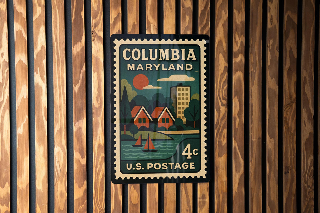 A vintage-style postage stamp from the United States of America, featuring a colorful illustration of a coastal town with houses, boats, and a sun.