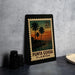 A framed postage stamp from the United States of America, featuring a tropical beach scene with palm trees and a sunset.