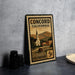 A vintage Concord, California postage stamp with a church and mountains in the background, sitting on a table next to some black camera lenses.