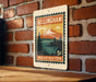 A vintage-style metal sign with a mountain landscape and text, mounted on a brick wall.