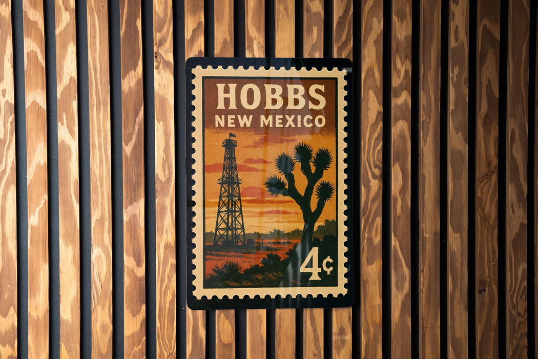 A postage stamp from New Mexico featuring a desert landscape with a tower in the background.