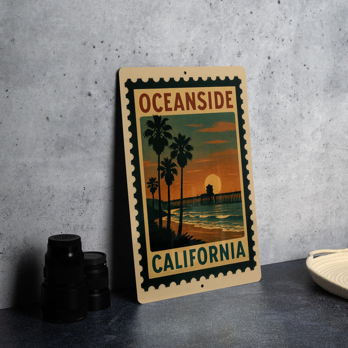 A vintage-style metal sign with the text "OCEANSIDE CALIFORNIA" and a sunset image of a beach and palm trees.