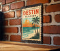 A vintage-style metal sign with the text "DESIN FLORIDA" is displayed on a brick wall, featuring a palm tree and a sunset scene.