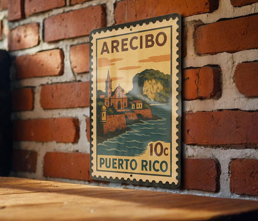A vintage-style stamp or sign with the text "ARECIBO PUERTO RICO 10c" displayed on a brick wall.